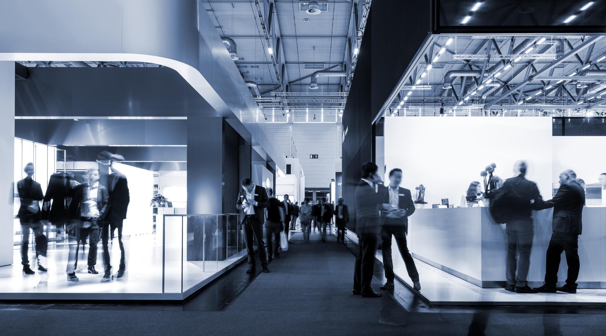 A trade show event with a crowd engaging in interactive booths.