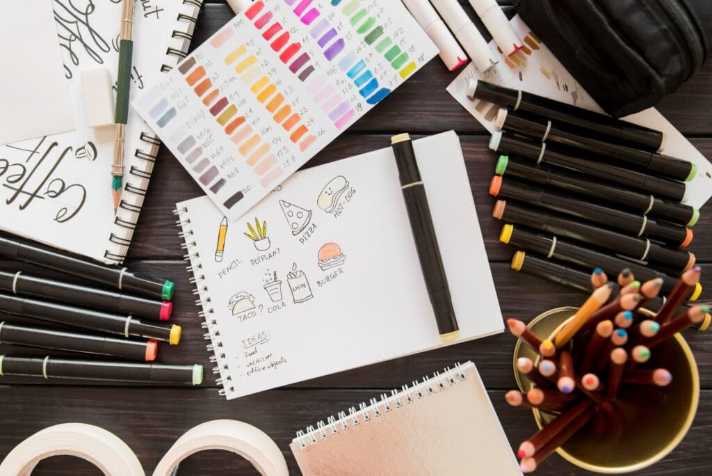 A designer’s desk with color palettes, brand books, and sketches.
