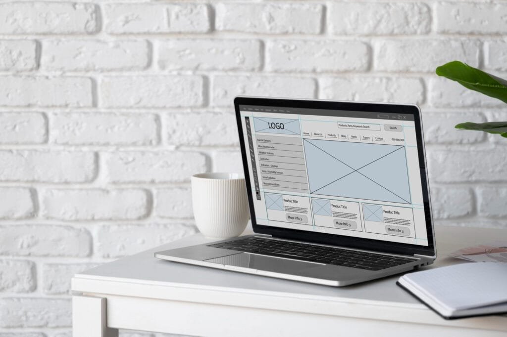 A sleek laptop displaying a responsive website layout with a clean UI.