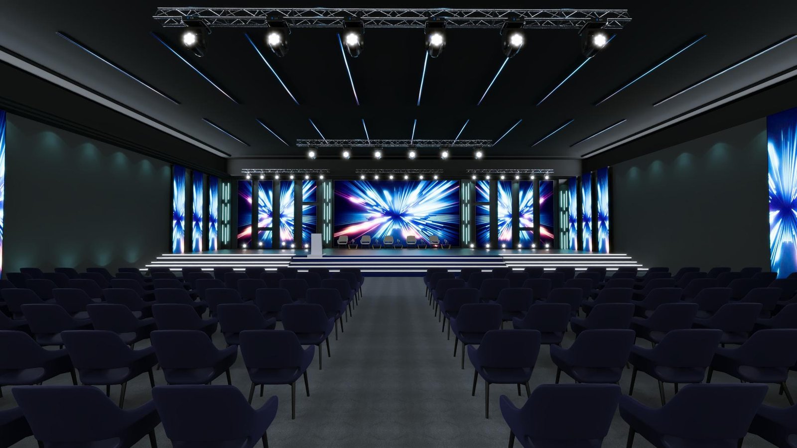 A decorated event hall with a stage, branding banners, and an audience.